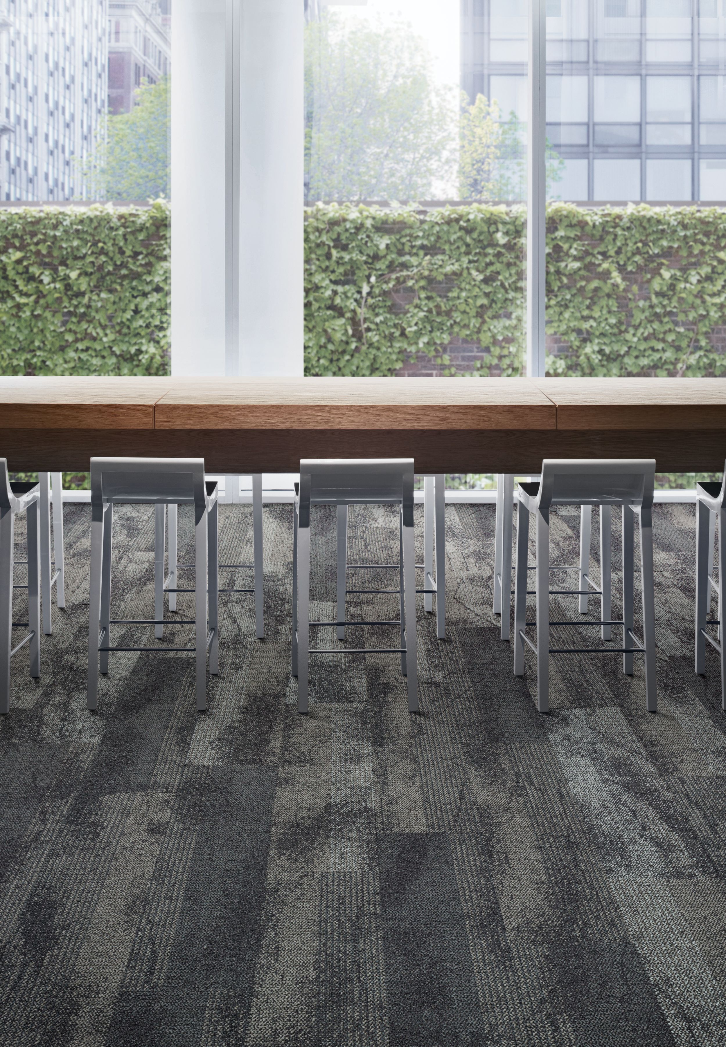 Interface Neighborhood Smooth plank carpet tile with hightop meeting table and glass windows showing ivy covered wall imagen número 3